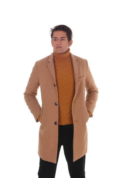 A young handsome man standing in a beige coat — Stock Photo, Image