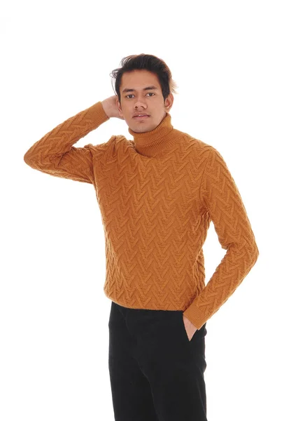 Pretty young man standing in a sweater in the studio — 스톡 사진