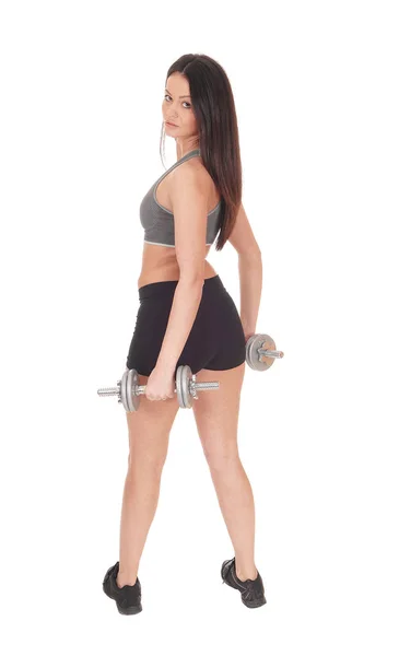 Woman standing from back with two dumbbells — Stock Photo, Image