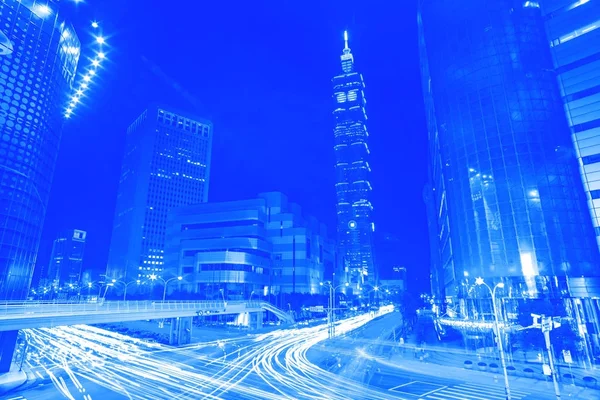 Blue style  light trails from vehicle traffic streak across a bu — Stock Photo, Image