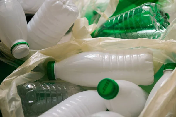 Used white and green plastic in the white bags — Free Stock Photo