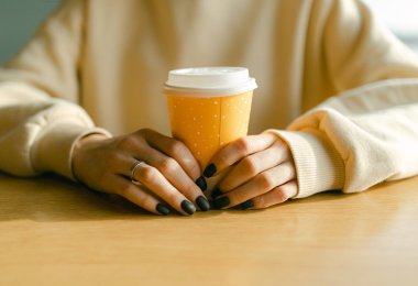 Young woman  with cup of tea in cafe