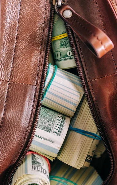 Leather bag with paper money, selective focus