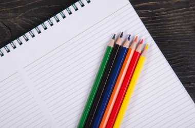 Renkli kalemler ve bir defter.