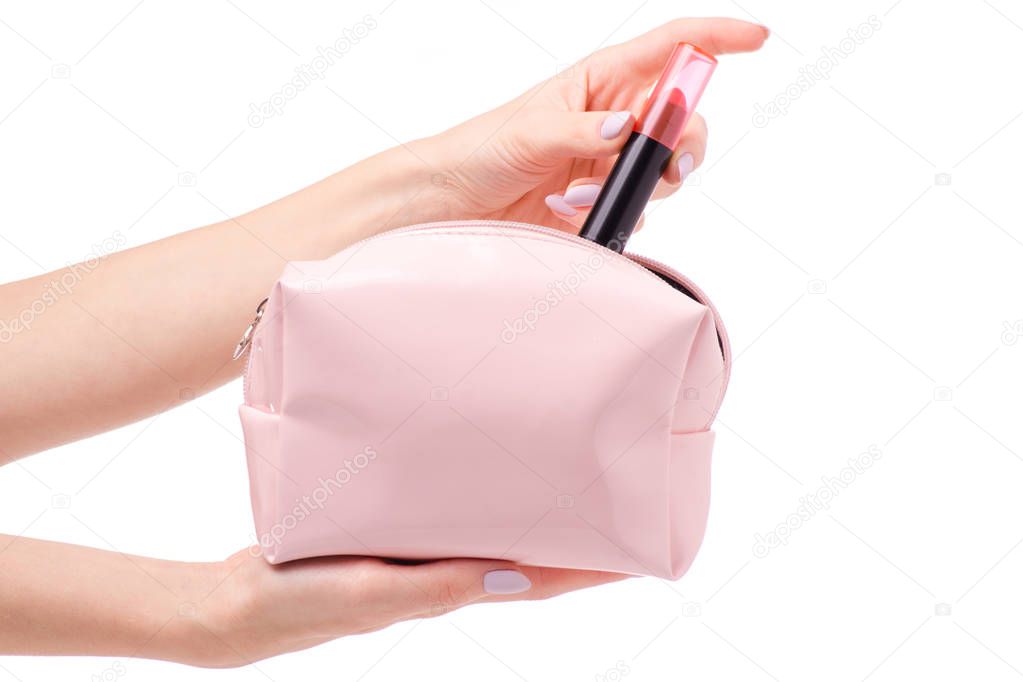 Pink open cosmetic bag in female hands with lipstick