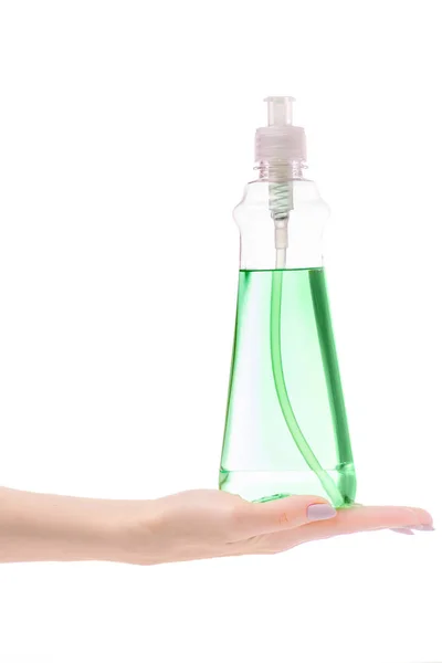 A női kéz mosogatószer tisztítószer üveg — Stock Fotó