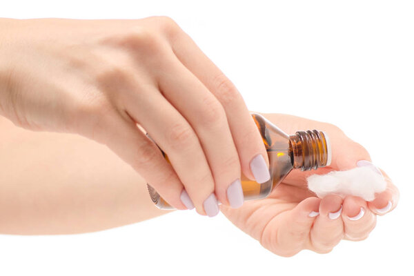 Female hand holding peroxide cotton wool in a glass jar of cotton wool