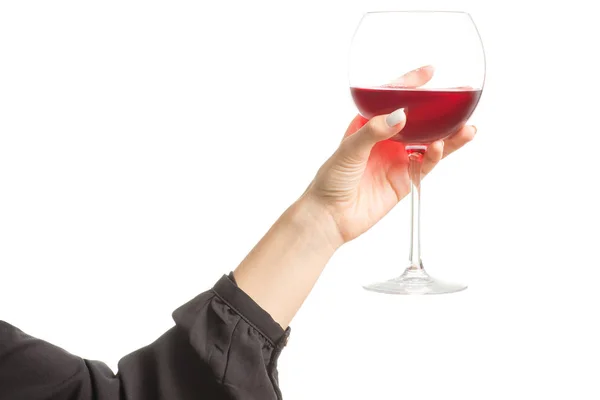 Female hand holding a glass of red wine — Stock Photo, Image