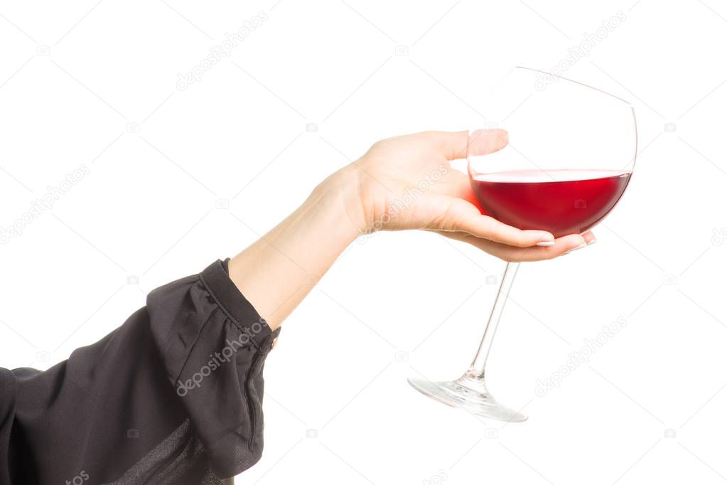 Female hand holding a glass of red wine