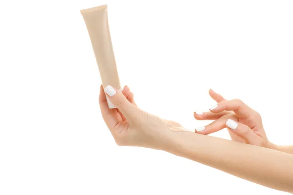 Female hand base cream beige — Stock Photo, Image