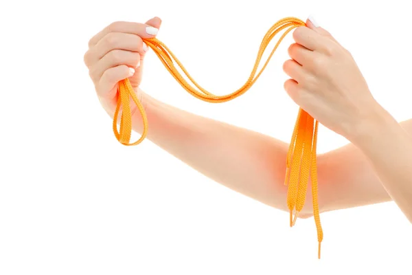 Ženské ruce zářivě oranžové tkaničky — Stock fotografie