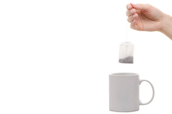 Fehér csésze tea bag női kéz — Stock Fotó
