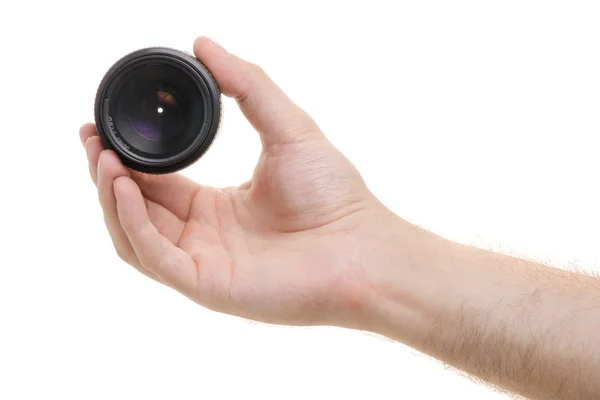 Lens on a camera in a male hand — Stock Photo, Image