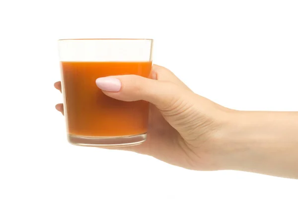 A glass of carrot-apple juice in a woman's hand — Stock Photo, Image