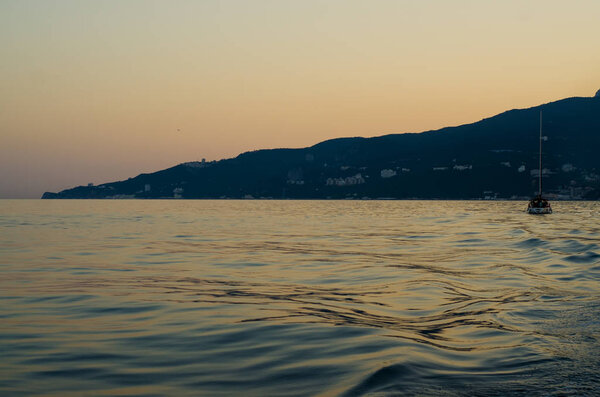 Sunset after the mountain sea ship