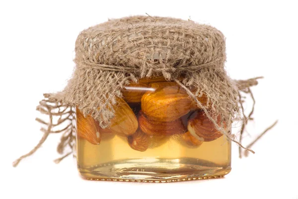 Un pot de miel aux amandes noix — Photo