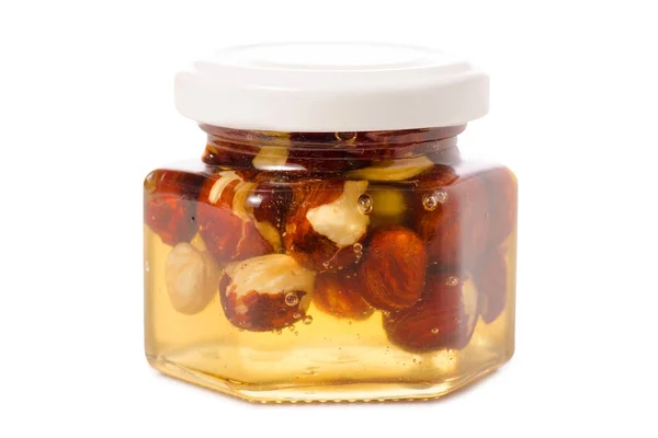 Un tarro de miel con nueces — Foto de Stock
