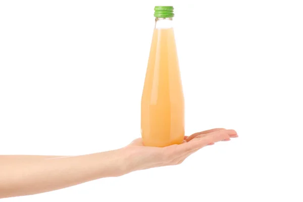 Glass bottle of juice in a hand — Stock Photo, Image