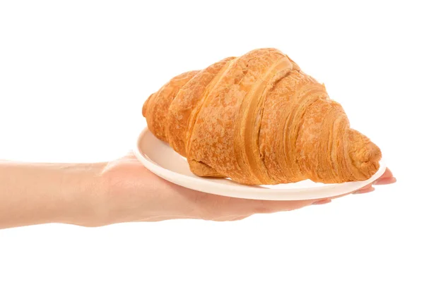 Croissant on a white plate in hand — Stock Photo, Image