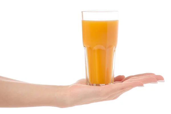 A glass of juice in the hand of an orange peach mango — Stock Photo, Image