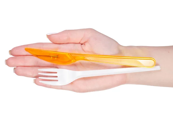 Пластиковая вилка и нож в руке — стоковое фото