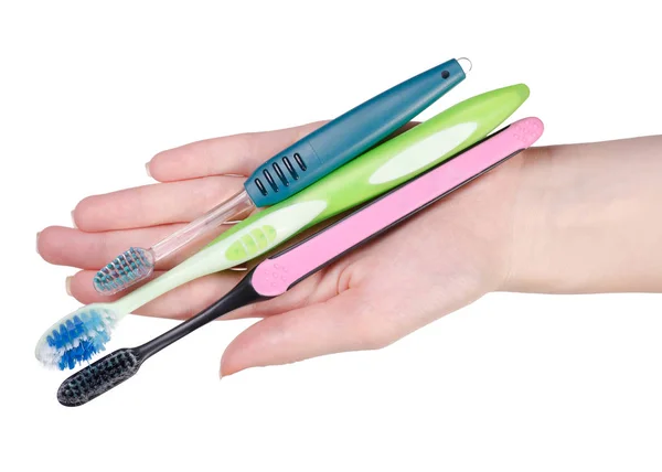 Toothbrushes in hand — Stock Photo, Image