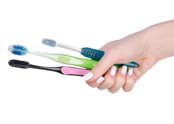 Toothbrushes in hand — Stock Photo, Image