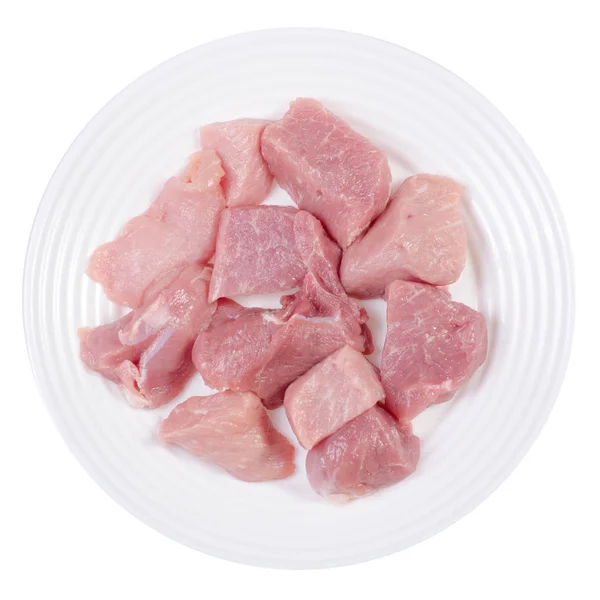 Pedaços de carne de porco cru em uma placa branca — Fotografia de Stock