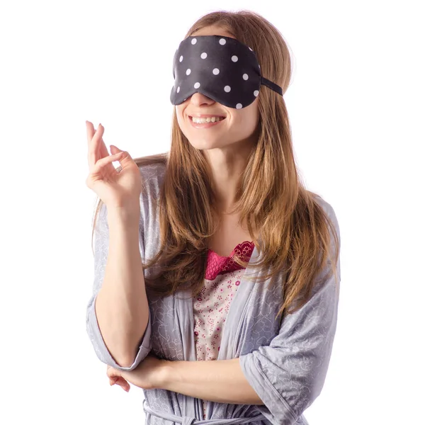 Young beautiful woman in a bathrobe with a sleeping mask — Stock Photo, Image