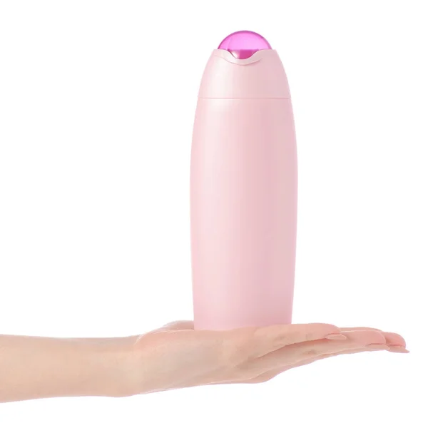 Shower gel in pink plastic bottle in hand — Stock Photo, Image