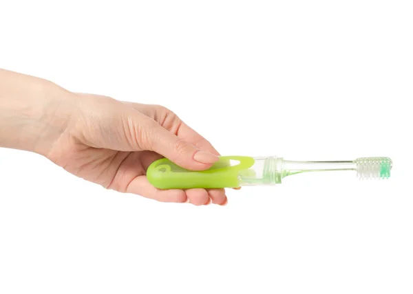 Viajar escova de dentes verde na mão — Fotografia de Stock