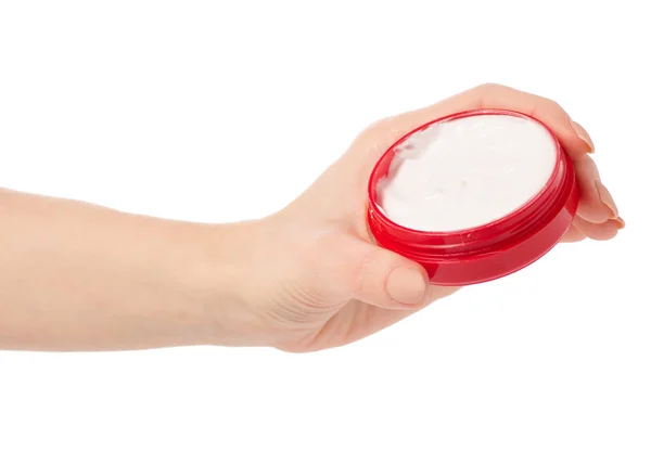 Crema corpo viso in un barattolo rosso in mano — Foto Stock