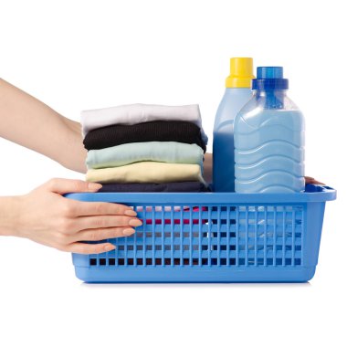 Elinde plastik sepeti sıvı toz saç kremi yumuşatıcı giysi yığını