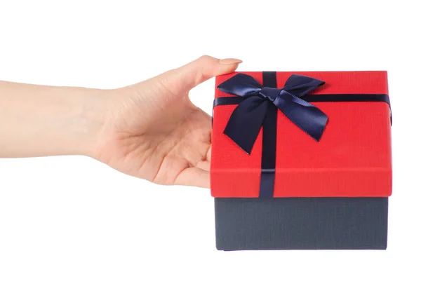 Gift box with a red lid and a blue bow in hand — Stock Photo, Image