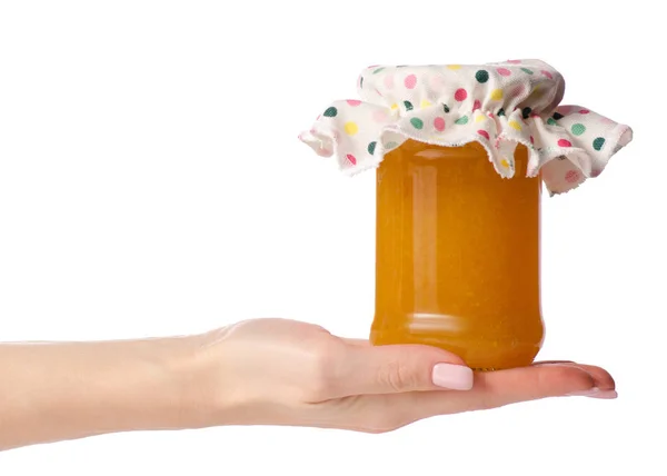 Mermelada de albaricoque naranja en una tapa del frasco en la mano —  Fotos de Stock