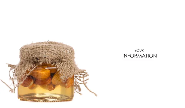 Un tarro de miel con patrón de nueces de almendras — Foto de Stock