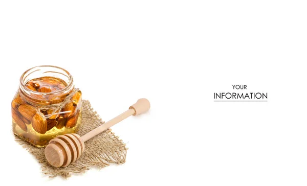Un barattolo di miele con un cucchiaio per il modello di mandorle di noci di miele — Foto Stock