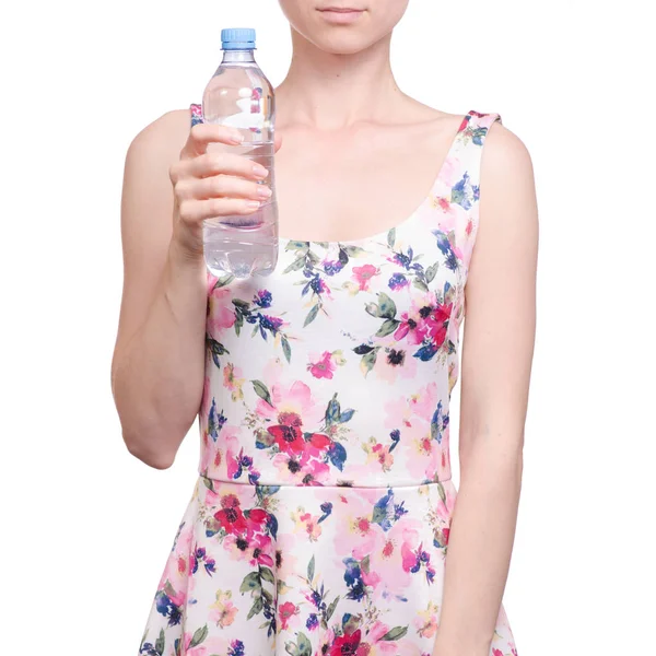 Žena v šatech květinovým potiskem v ruce láhev vody jaro léto — Stock fotografie
