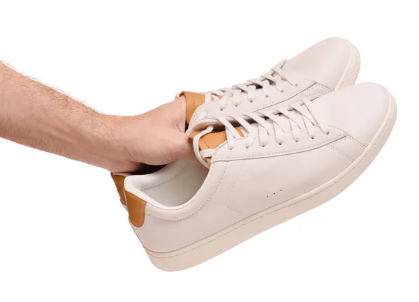 White leather male sneakers shoes on laces in hand — Stock Photo, Image