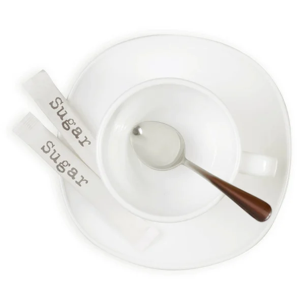 Copa blanca y platillo de azúcar palos cuchara — Foto de Stock