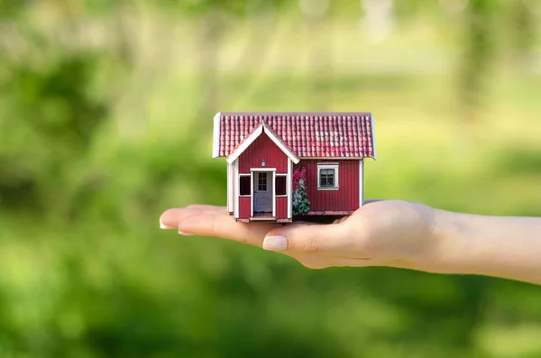 Klein huis in handen zon groen — Stockfoto