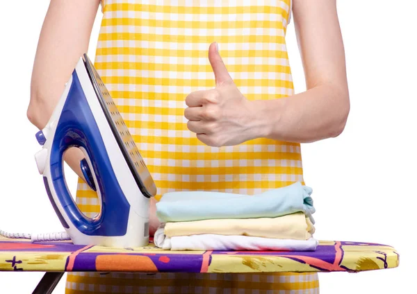 Woman in apron with iron ironing board laundry clothes