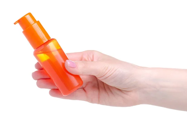 Orange sunscreen suntan bottle in hand — Stock Photo, Image