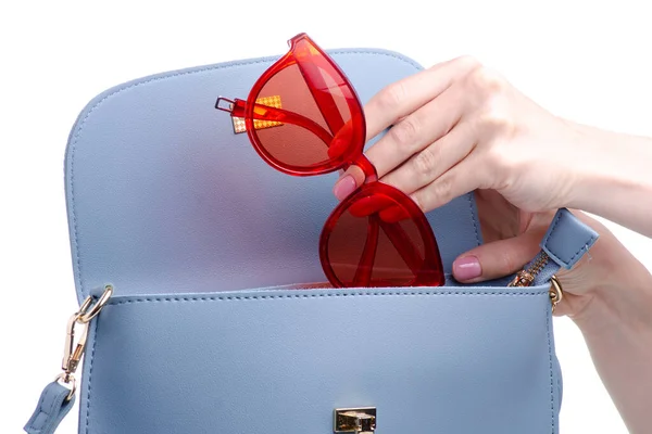 Red sunglasses put in blue bag — Stock Photo, Image