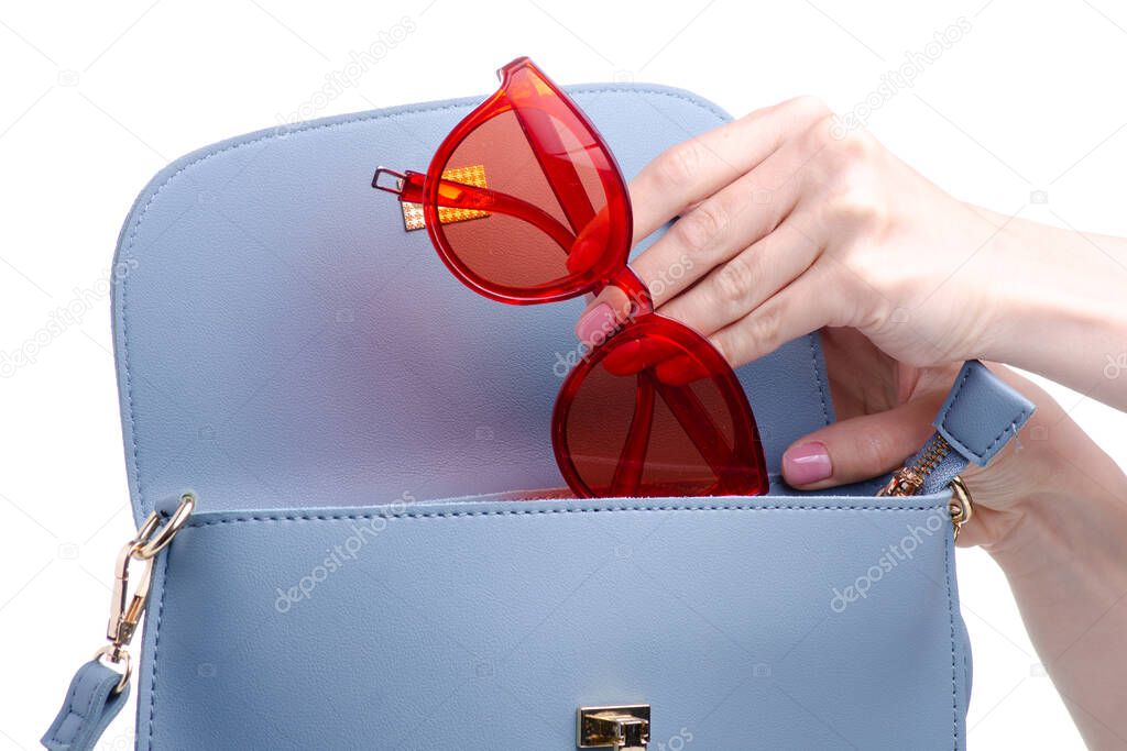 Red sunglasses put in blue bag