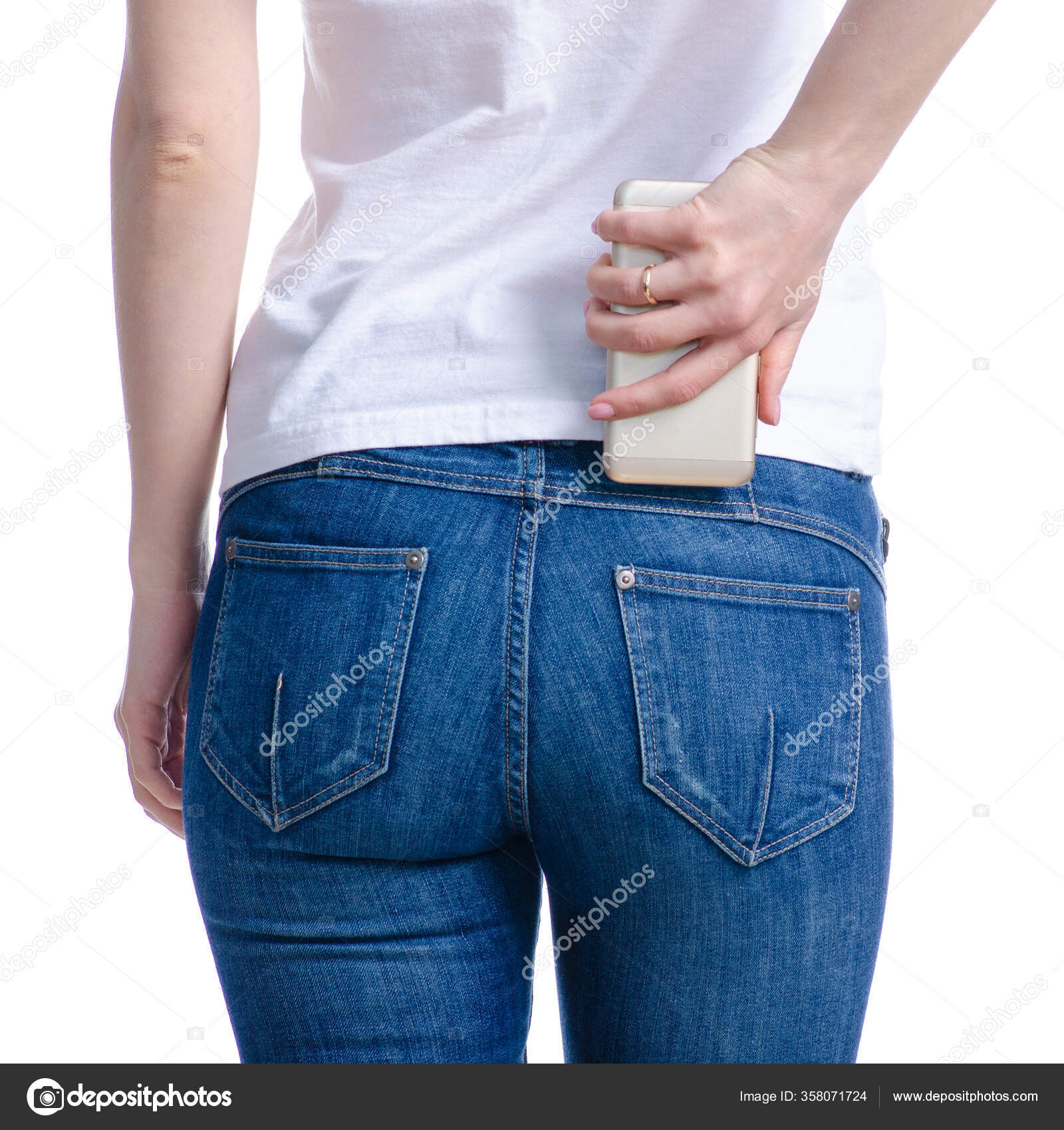 Woman puts mobile phone in jeans pocket — Stock Photo © Evgenyjs1