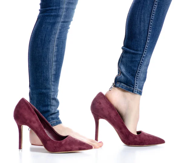 Female legs in jeans red high heels beauty pain — Stock Photo, Image