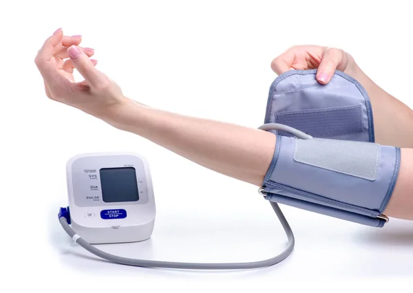 Digital blood pressure monitor electric tonometer in hand — Stock Photo, Image