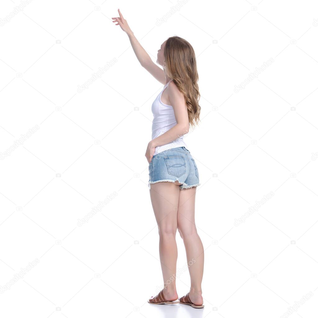 Woman in denim shorts standing looking showing pointing