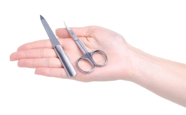 Manicure nail file and scissors in hand — Stock Photo, Image